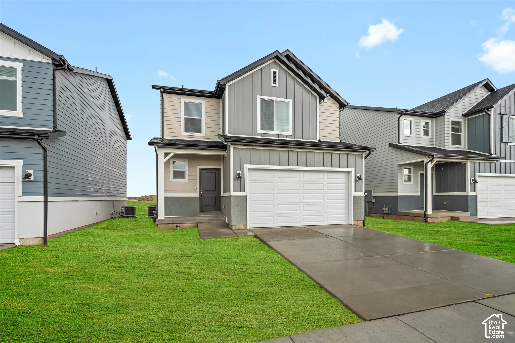 **DISCLAIMER** Elevation and exterior color may vary. Two-story exterior featuring board-and-batten siding, a covered entryway, a concrete driveway, and an attached two-car garage