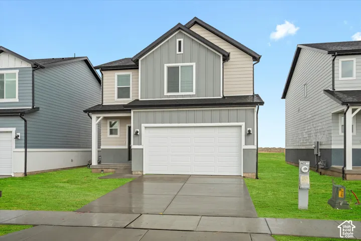 **DISCLAIMER** Elevation and exterior color may vary. Exterior featuring mixed board-and-batten and horizontal siding, two-car garage, concrete driveway, and covered front entry