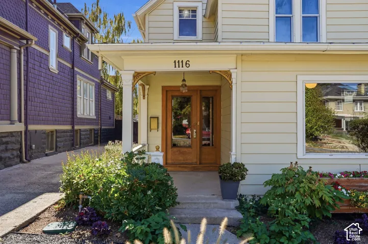 Original wood and glass door with beautifully restored front porch light.