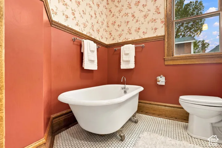 Gorgeous refinished clawfoot tub with penny-tile flooring and new paint.