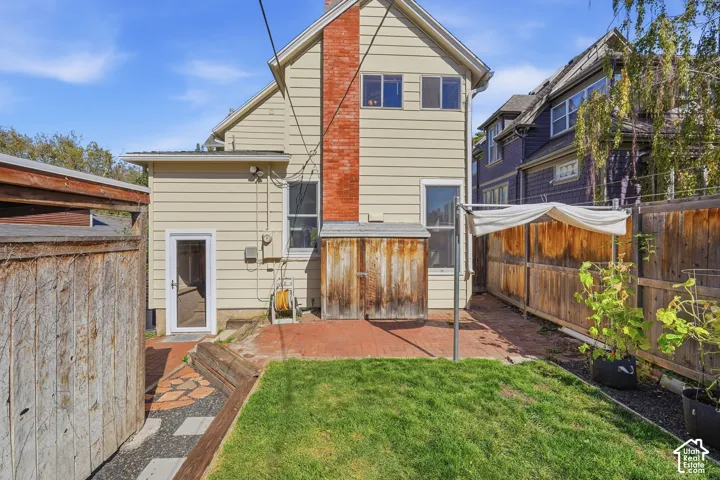 Spacious backyard with graveled terraces built for container gardening with specially engineered sun shades.