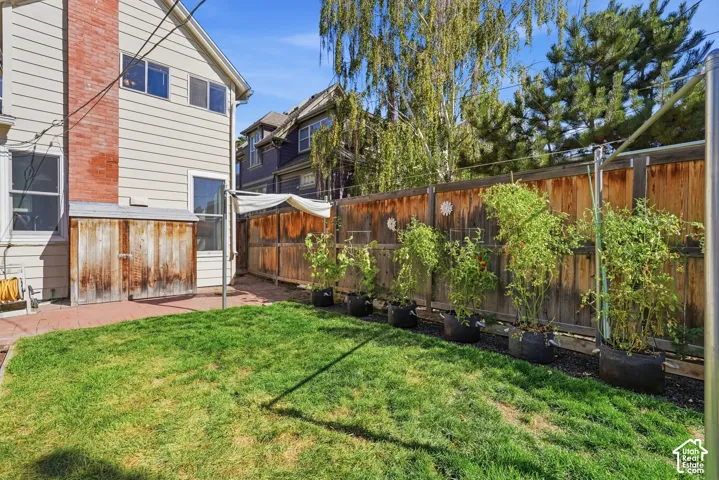 Spacious backyard with graveled terraces at two levels purposefully built for container gardening with specially engineered sun shades to protect plants on the hottest summer days.