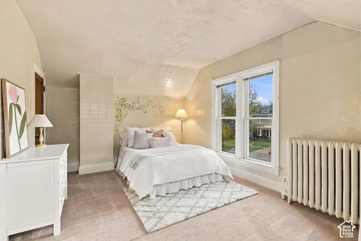 Charming bedroom with windows and a closet.