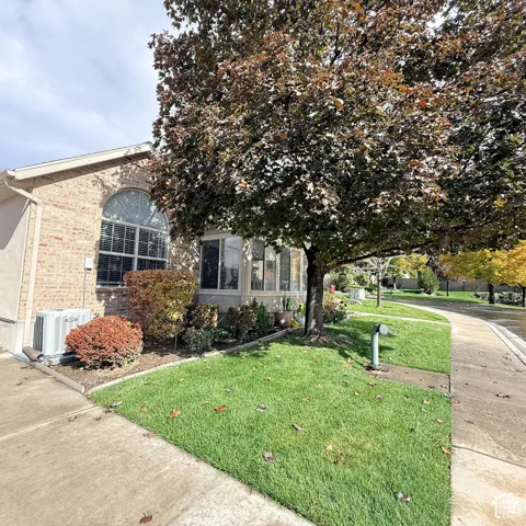 Side view leading to driveway/garage