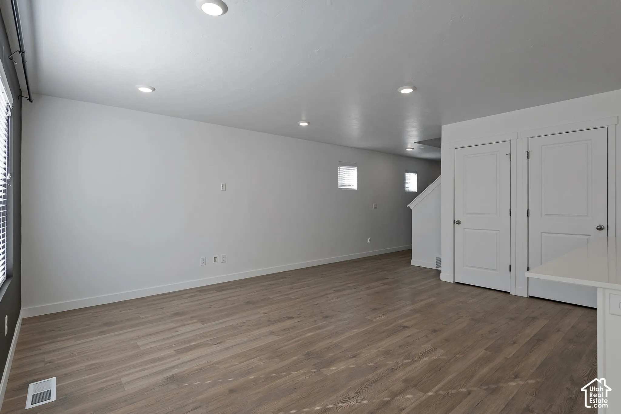 Interior space featuring wood-finish flooring, recessed lighting, and two interior panel doors