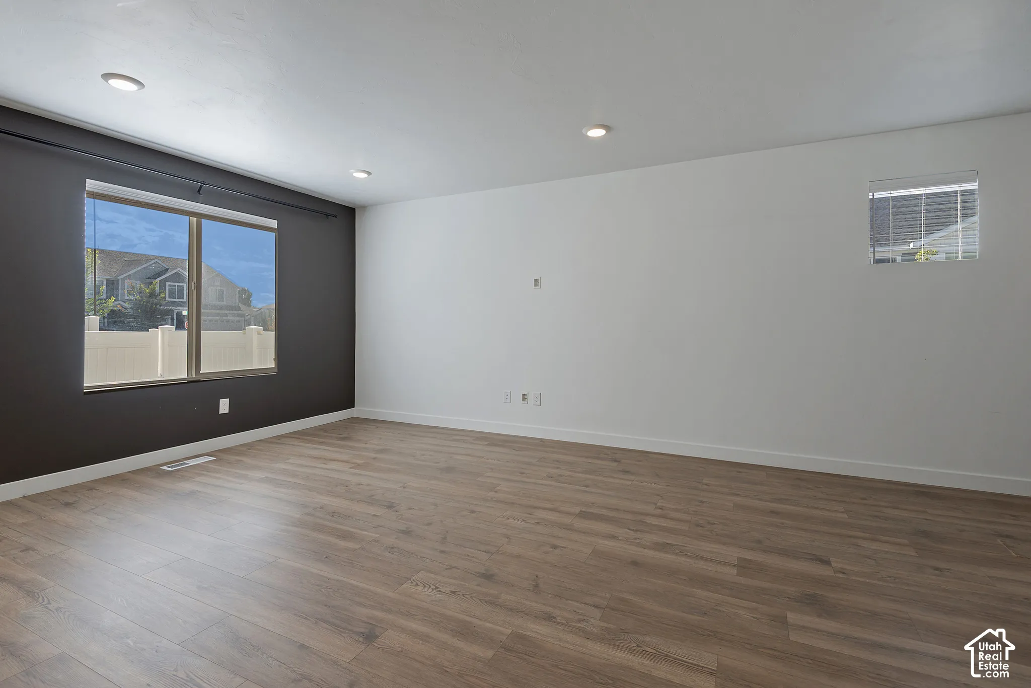 Interior space featuring wood-finish flooring, recessed lighting, and a dark accent wall