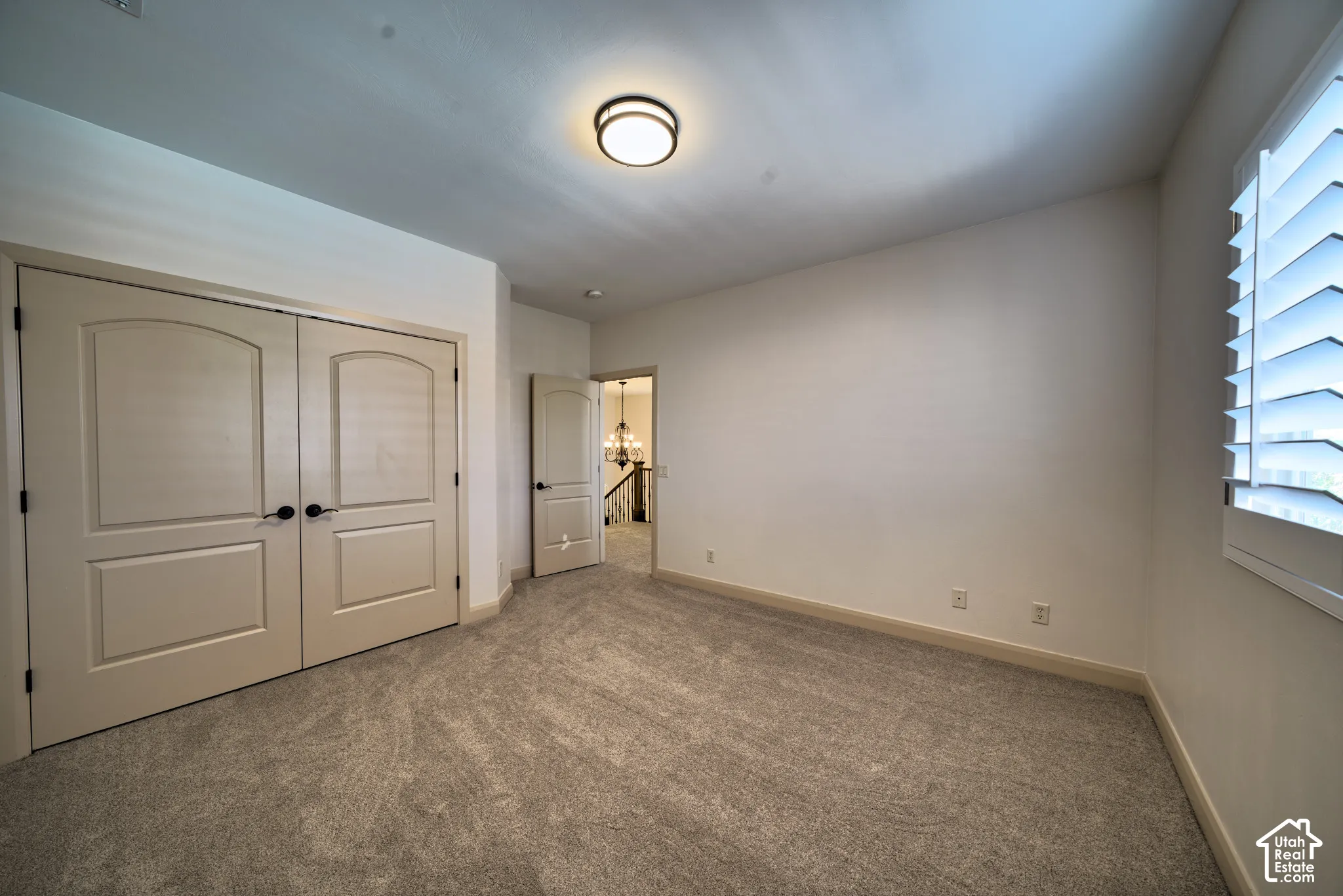 Upstairs bedroom with a double-door closet.