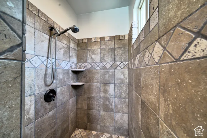 Walk-in tile shower in the primary bathroom.