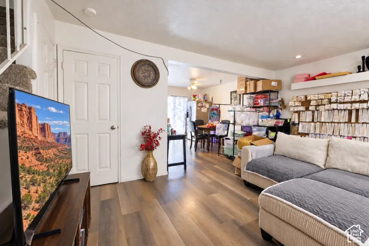 Wood-finish flooring throughout the main level and a white paneled door