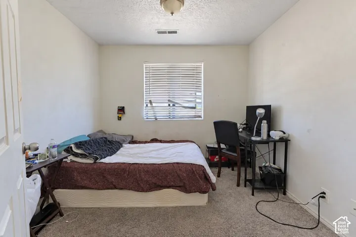 Room featuring neutral wall finishes, carpeted flooring, and a window with horizontal blinds