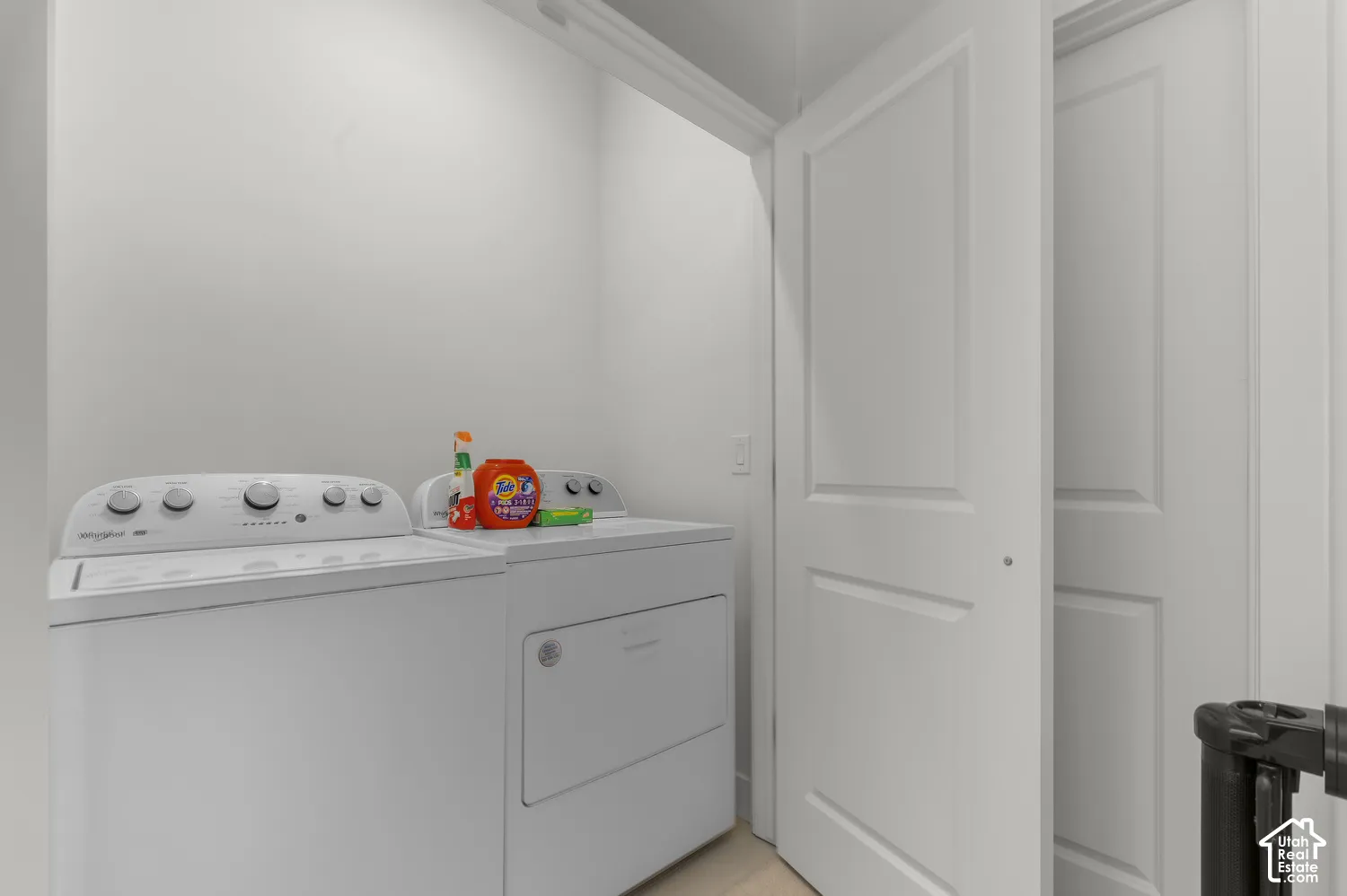 Dedicated utility area featuring white panel doors and neutral walls