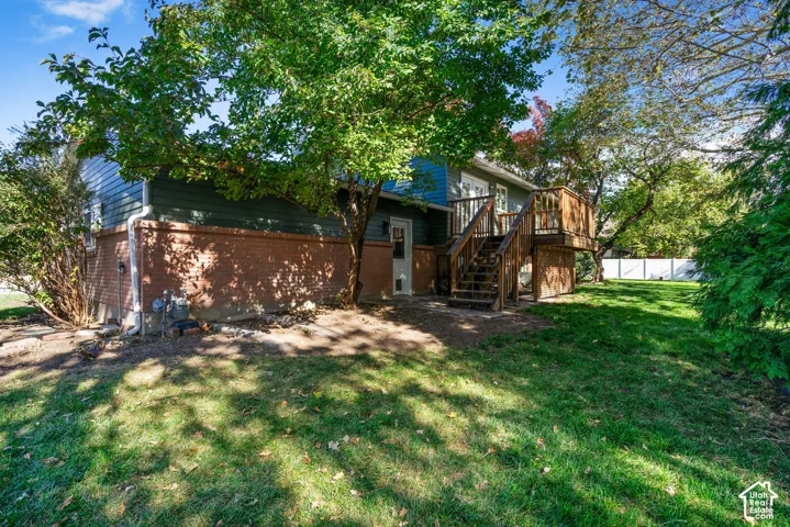 Rear exterior featuring a brick and horizontal siding fa