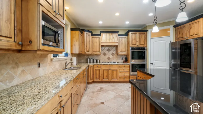 Kitchen featuring wood cabinetry, stone countertops, stone tile backsplash, stainless steel double wall ovens, and tile flooring