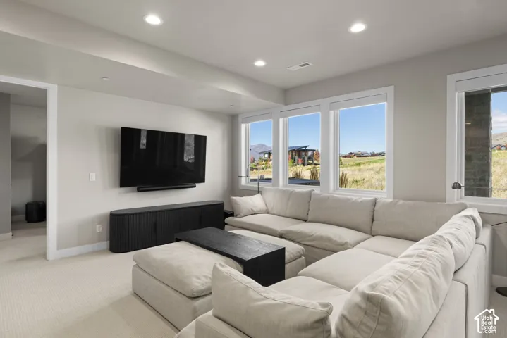 Interior space featuring recessed lighting, carpeting, and multiple large windows with mountain and landscape scenery