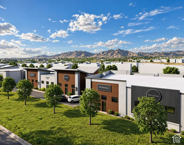 Commercial complex featuring multi-tenant buildings with wood-panel siding, corrugated metal accents, shed roofs, and an expansive mountain backdrop