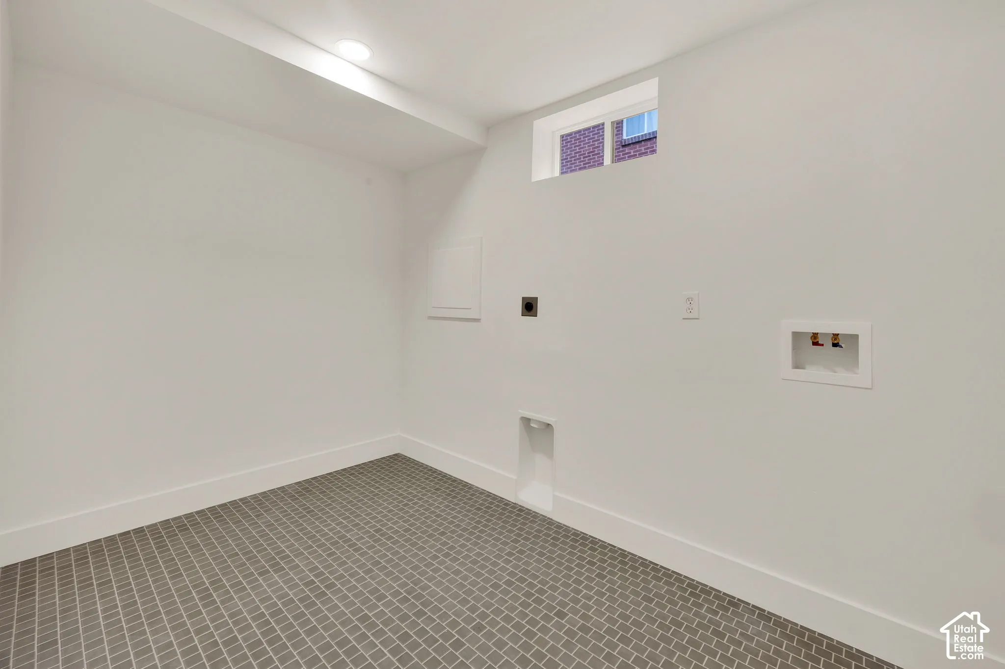 Tiled laundry room in lower level