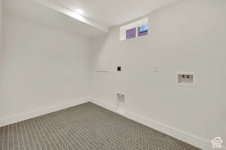 Tiled laundry room in lower level