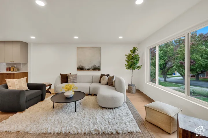 Open-concept living space featuring wood flooring, recessed lighting, and expansive horizontal windows