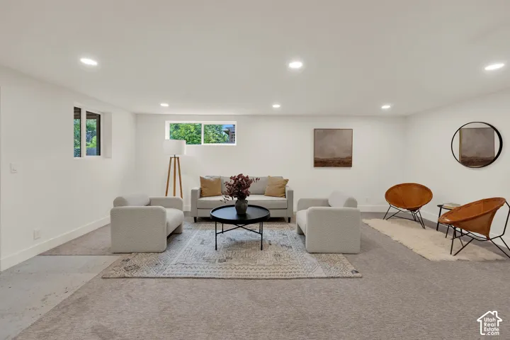 Neutral color palette, recessed lighting, carpeted flooring, and slider windows