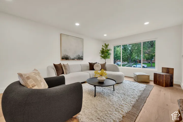 Living area featuring wood flooring, recessed lighting, and a large picture window