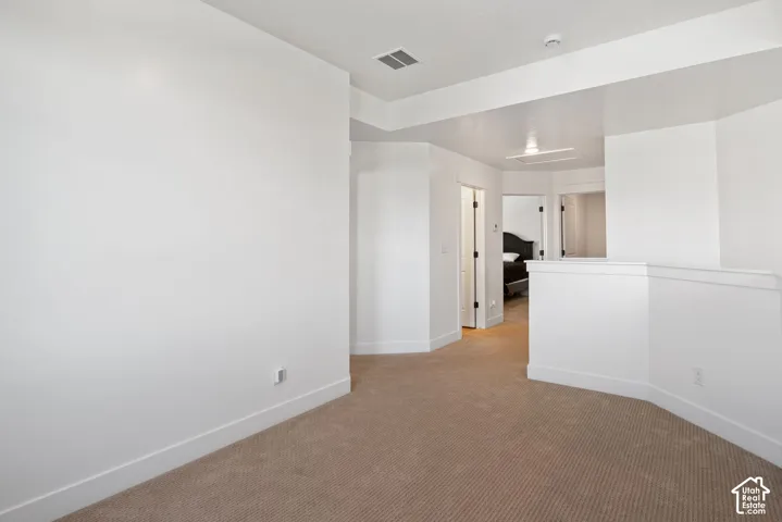 Neutral wall tones, wall-to-wall carpeting, and architectural cutouts