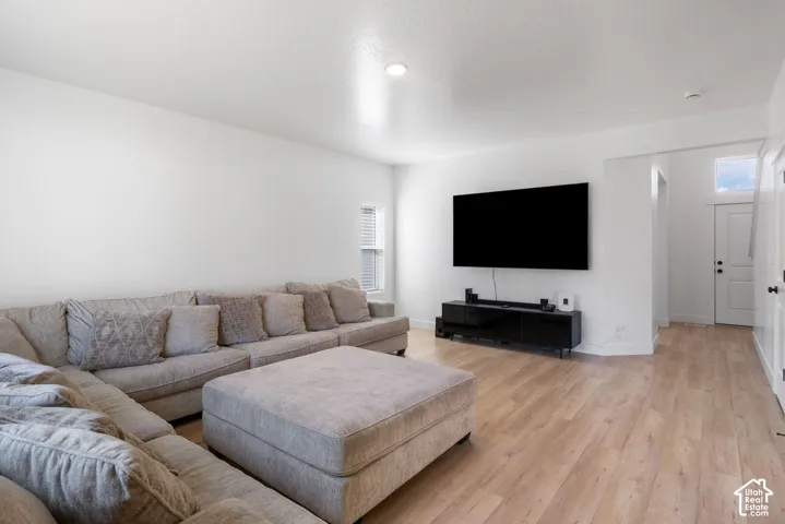 Living area featuring wood-finish flooring, recessed lighting, and neutral wall paint