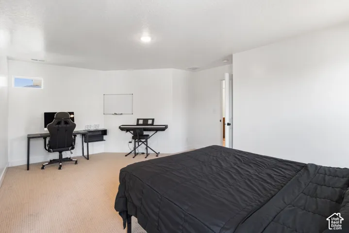 Neutral-toned carpeting, crisp white walls, flush-mount lighting, and a horizontal clerestory window