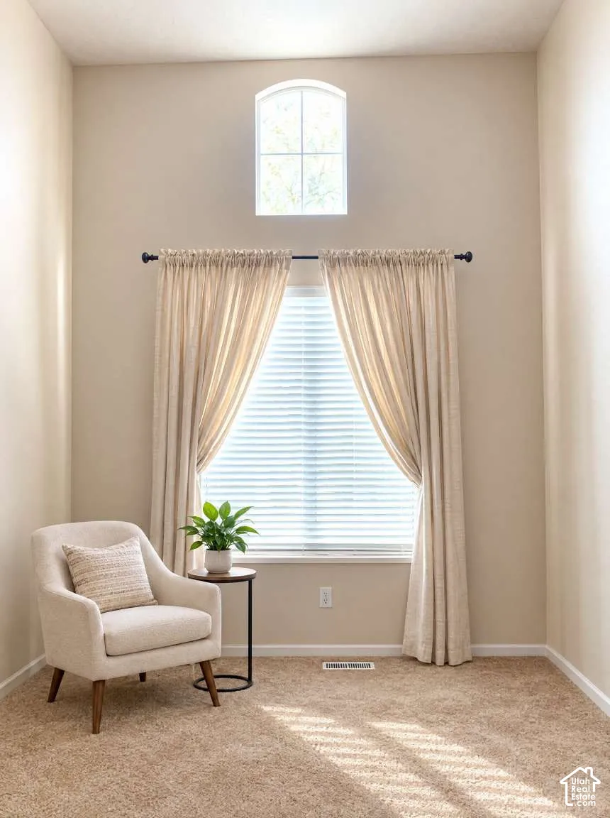 High ceilings, large window with horizontal blinds, and a decorative arched transom window