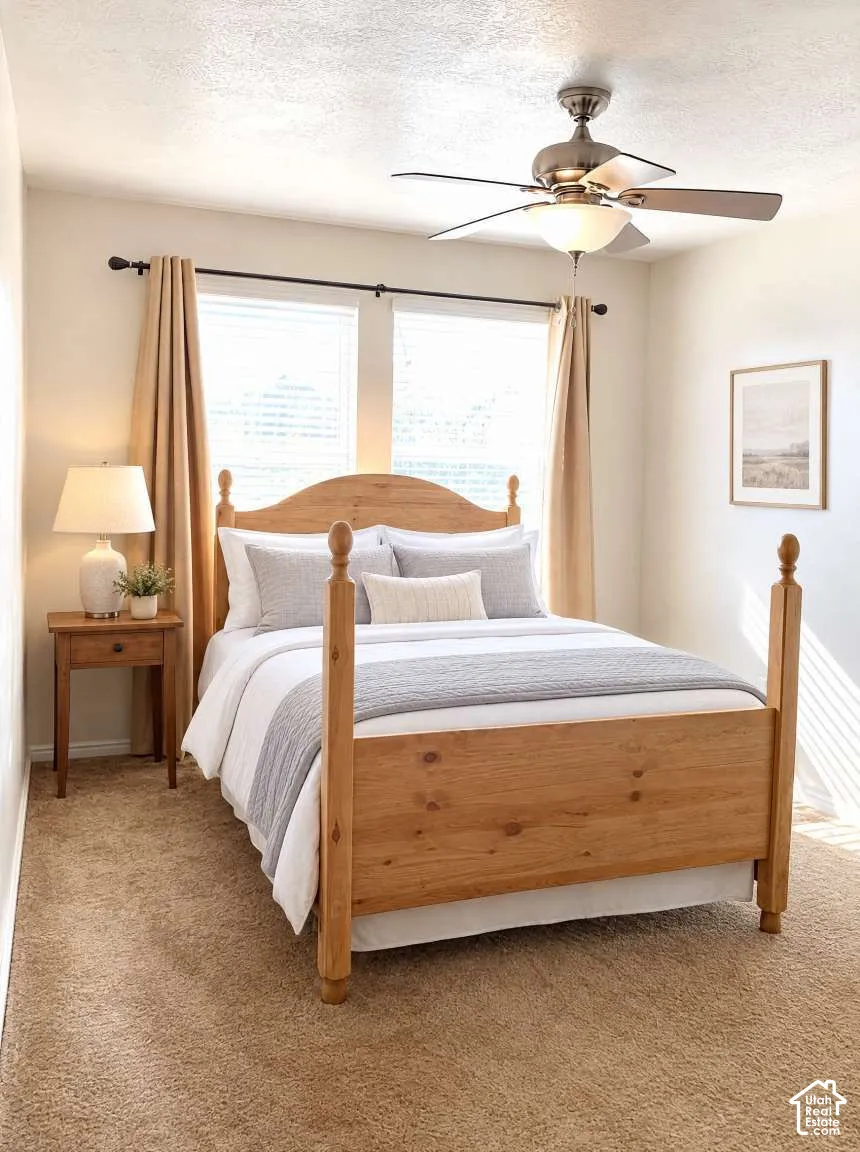 Room featuring wall-to-wall carpeting, dual windows with curtain rods, and a ceiling fan with integrated lighting