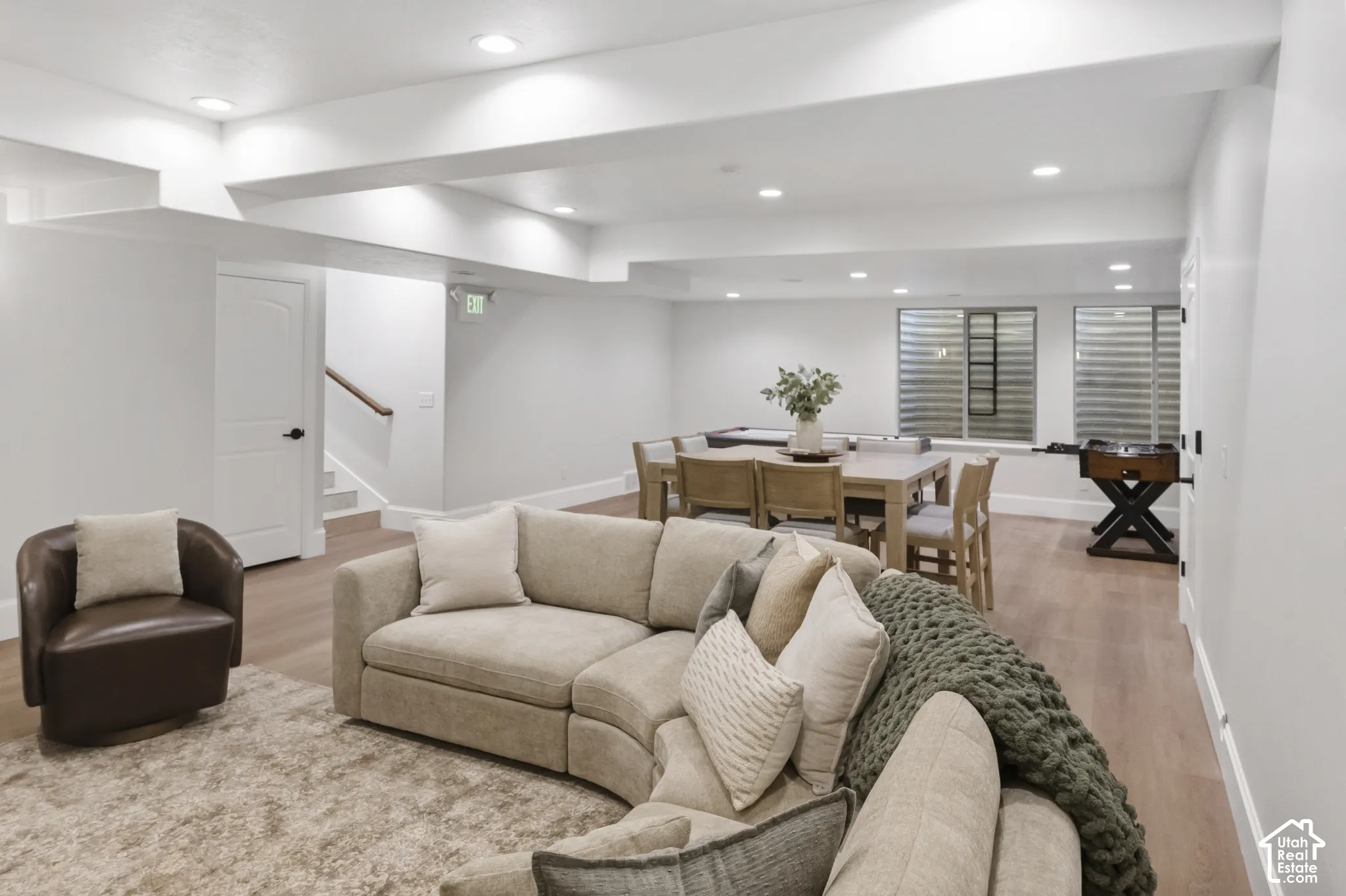 Community game room with spacious interior featuring recessed lighting, wood-finish flooring, and recessed windows