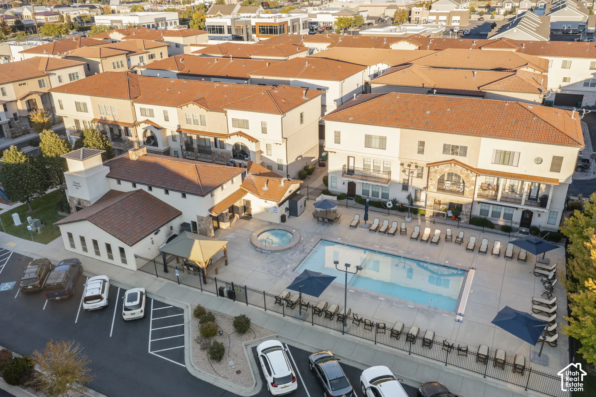 Community amenities featuring an outdoor swimming pool, spa, and covered gazebo area, complemented by terracotta-style roof tiles