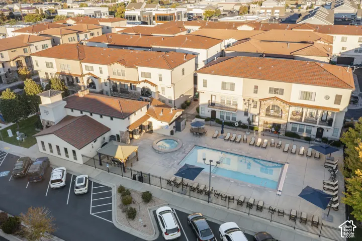 Community amenities featuring an outdoor swimming pool, spa, and covered gazebo area, complemented by terracotta-style roof tiles