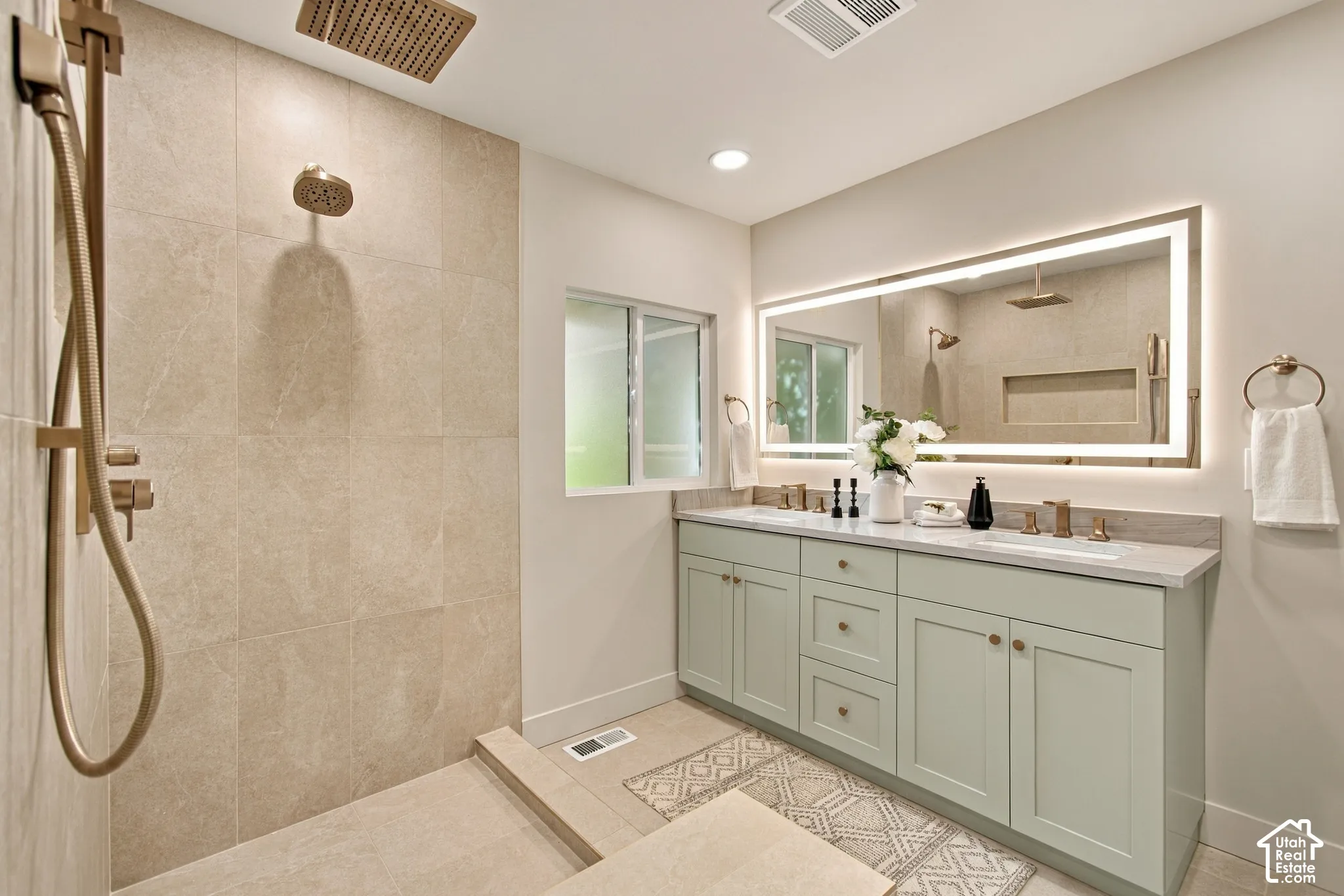Walk-in shower featuring tile surround, ceiling-mounted rainfall showerhead, and brass-tone fixtures