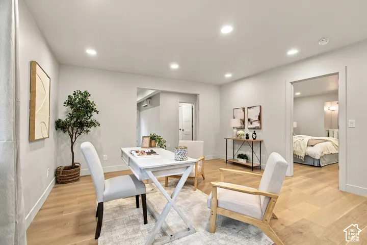 Interior space featuring light wood-finish flooring, recessed lighting, and crisp neutral wall paint