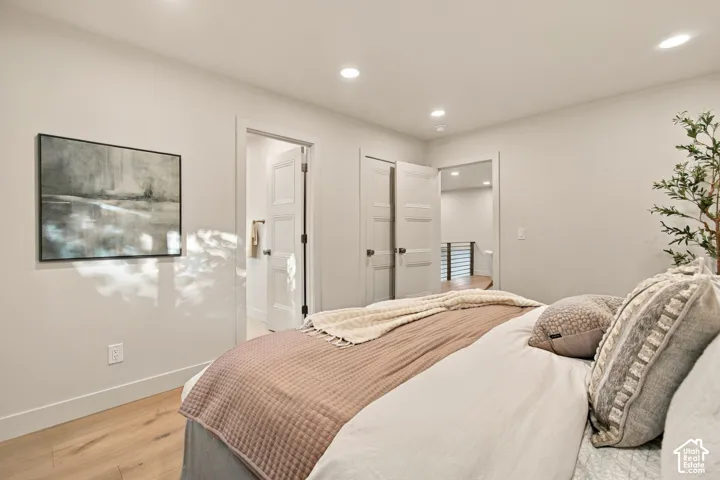 Interior space featuring wood-finish flooring, recessed lighting, and multi-panel interior doors