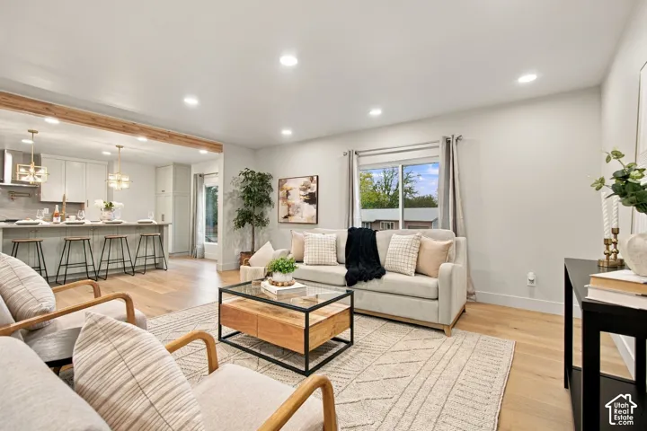 Open-concept interior featuring wood-finish flooring, recessed lighting, and a kitchen island with pendant lighting