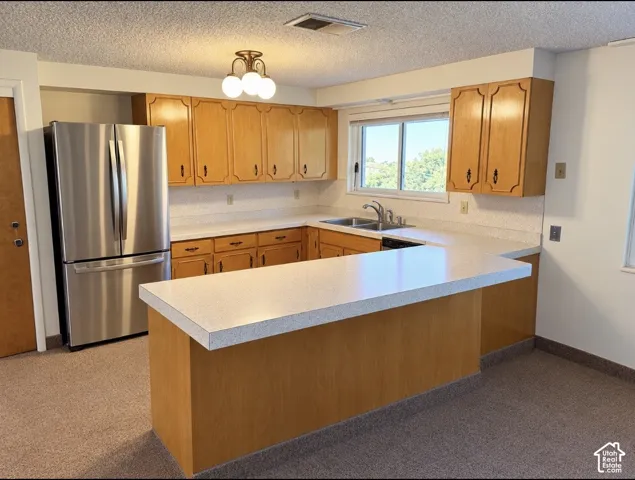 Kitchen featuring wood cabinetry, a peninsula countertop