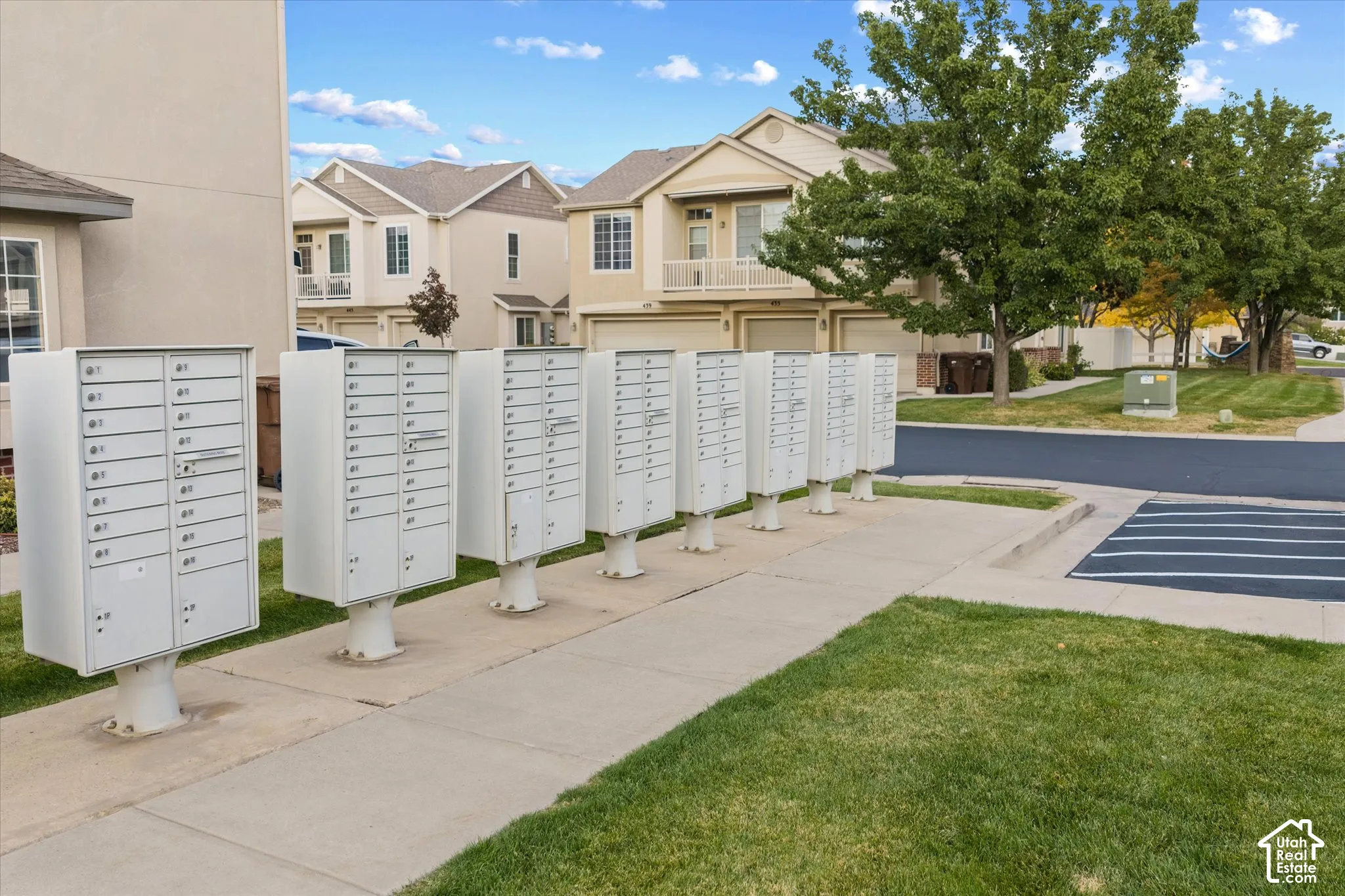Centralized metal mailbox clusters situated on a concrete pedestal pad