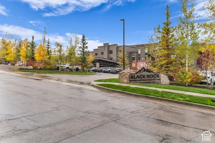 Black Rock Mountain Resort exterior featuring a stone-clad monument sign, paved driveway, asphalt roads, and mature landscaping