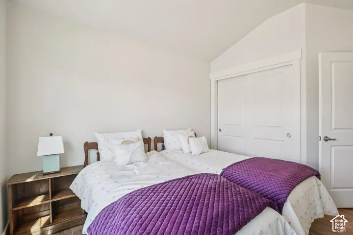 Vaulted ceilings, sliding closet doors with crisp white trim, and white panel doors