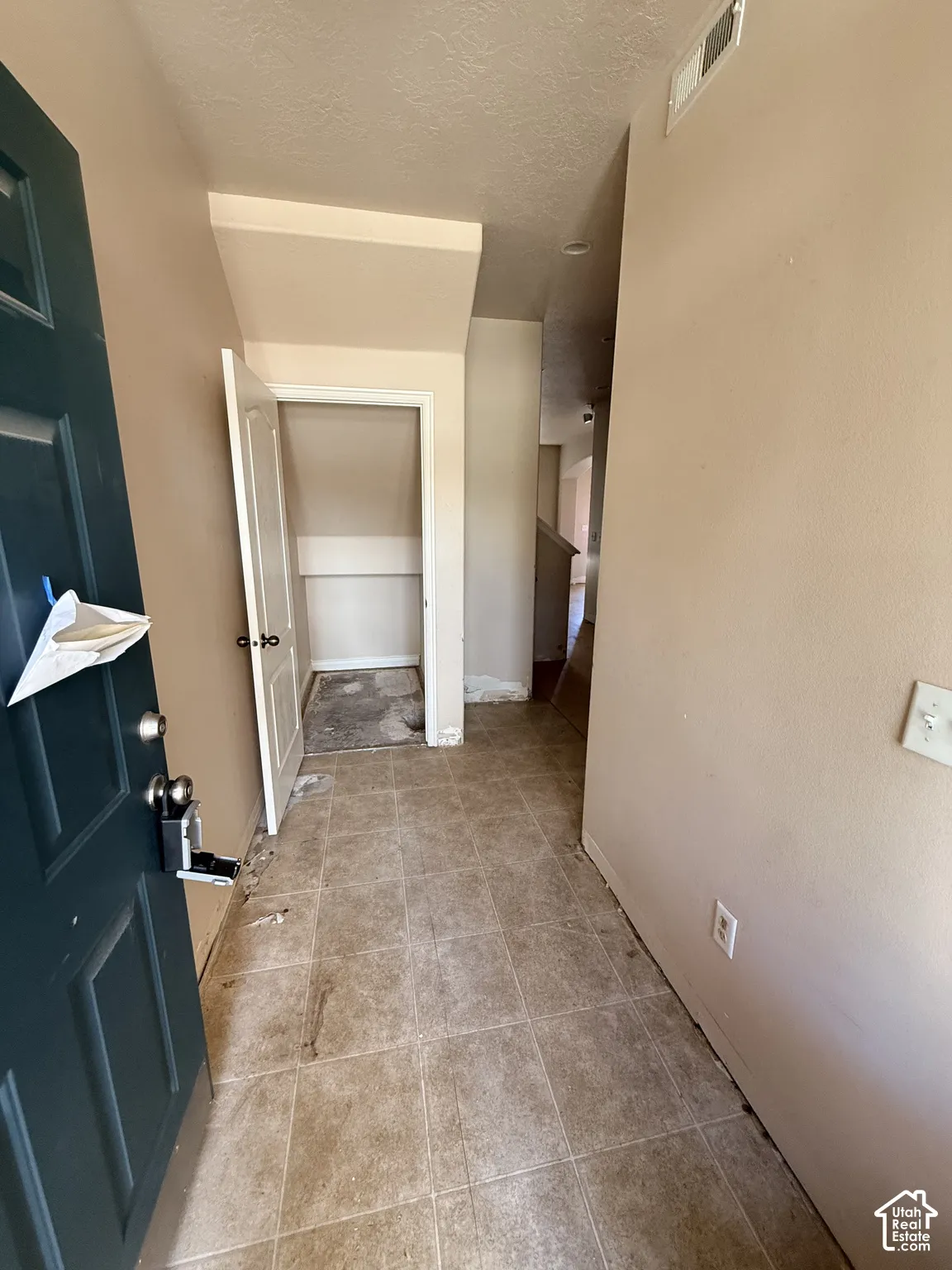 Entryway featuring tile flooring and built-in storage closet