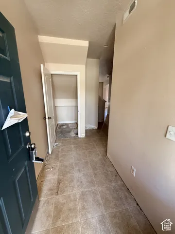 Entryway featuring tile flooring and built-in storage closet