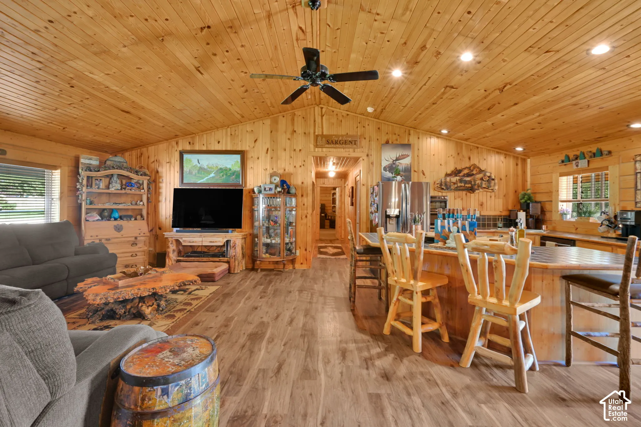 Living room off of the kitchen and dining, open floor plan with vaulted ceiling.