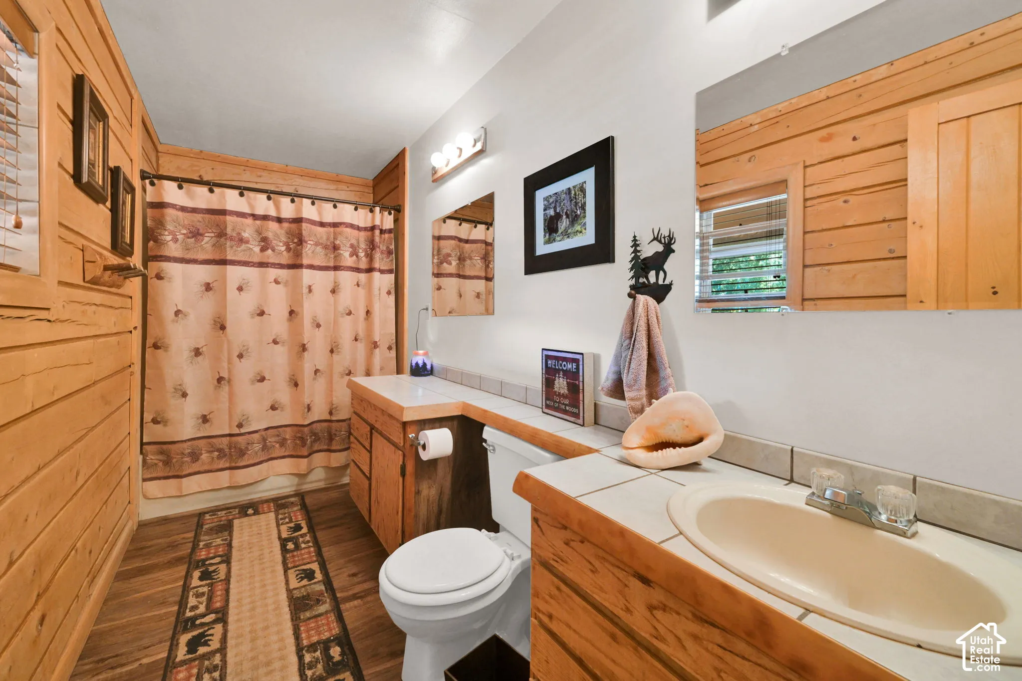 Full bathroom down other hallway, accessible to 3 bedrooms nearby and the whole home