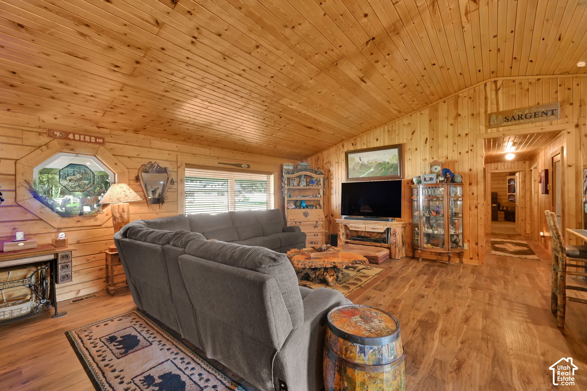 Living room off of the kitchen and dining, open floor plan with vaulted ceiling.