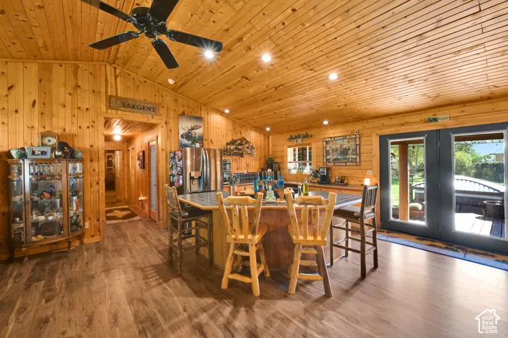 Open Kitchen with immaculate wood detailing, vaulted ceiling and island.