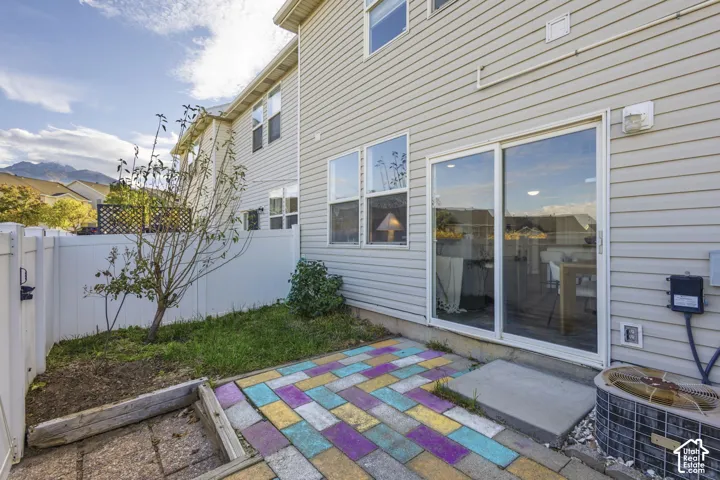 Exterior featuring horizontal siding, vinyl fencing, and a ground-level paver patio