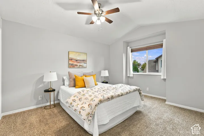 Primary bedroom with vaulted ceilings