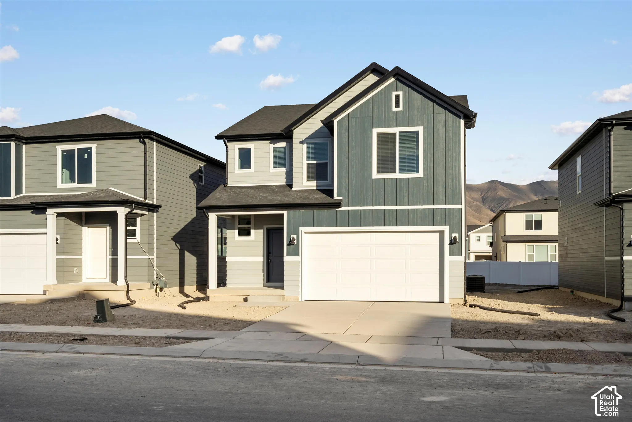**DISCLAIMER** Elevation and exterior colors may vary.  Two-story exterior featuring vertical and horizontal siding, a gabled roofline, a two-car garage, and a concrete driveway