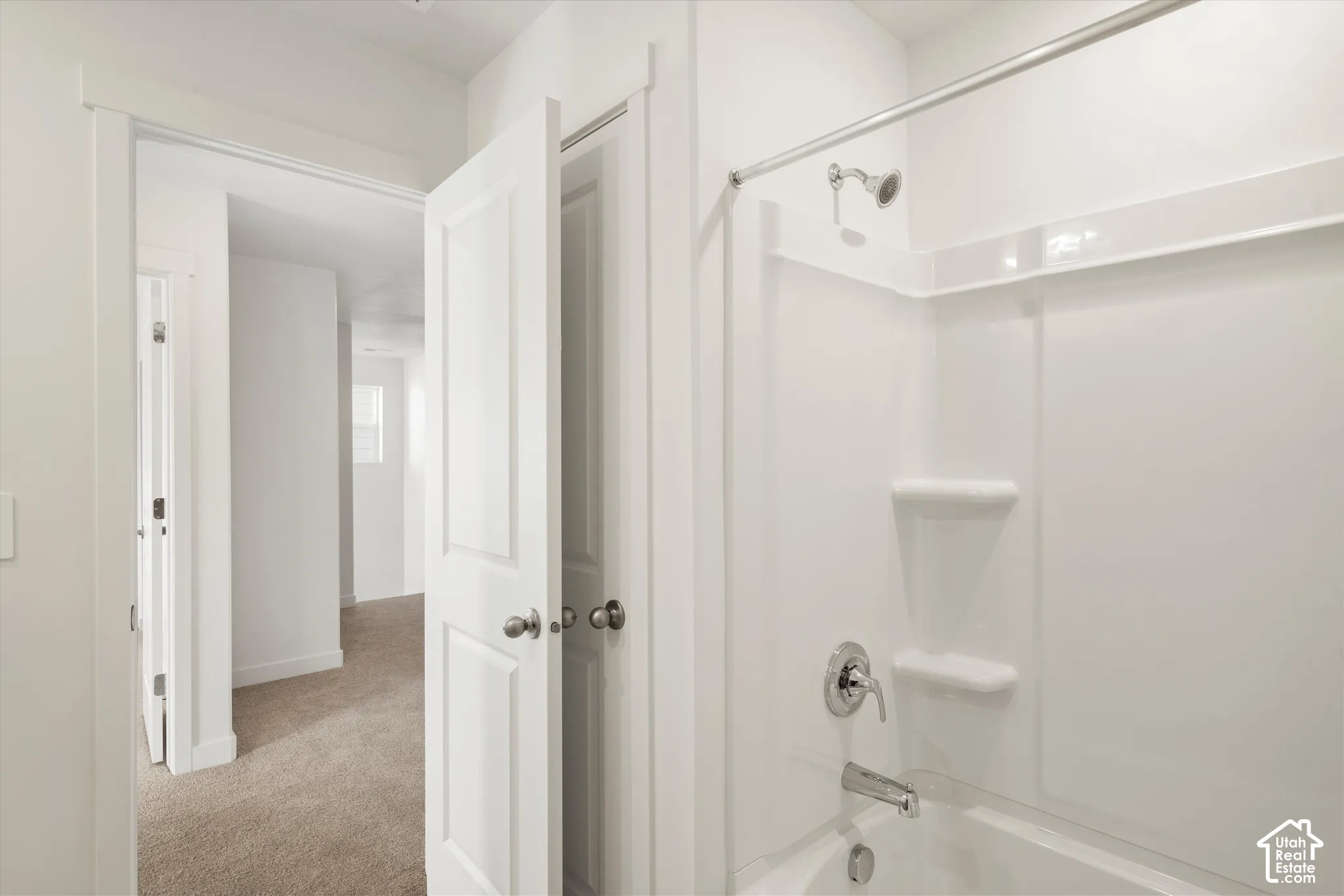 **Disclaimer** Interior package & colors may vary.  Shower and tub combination with a white molded surround, single-handle faucet, integrated shelving, and metal shower rod